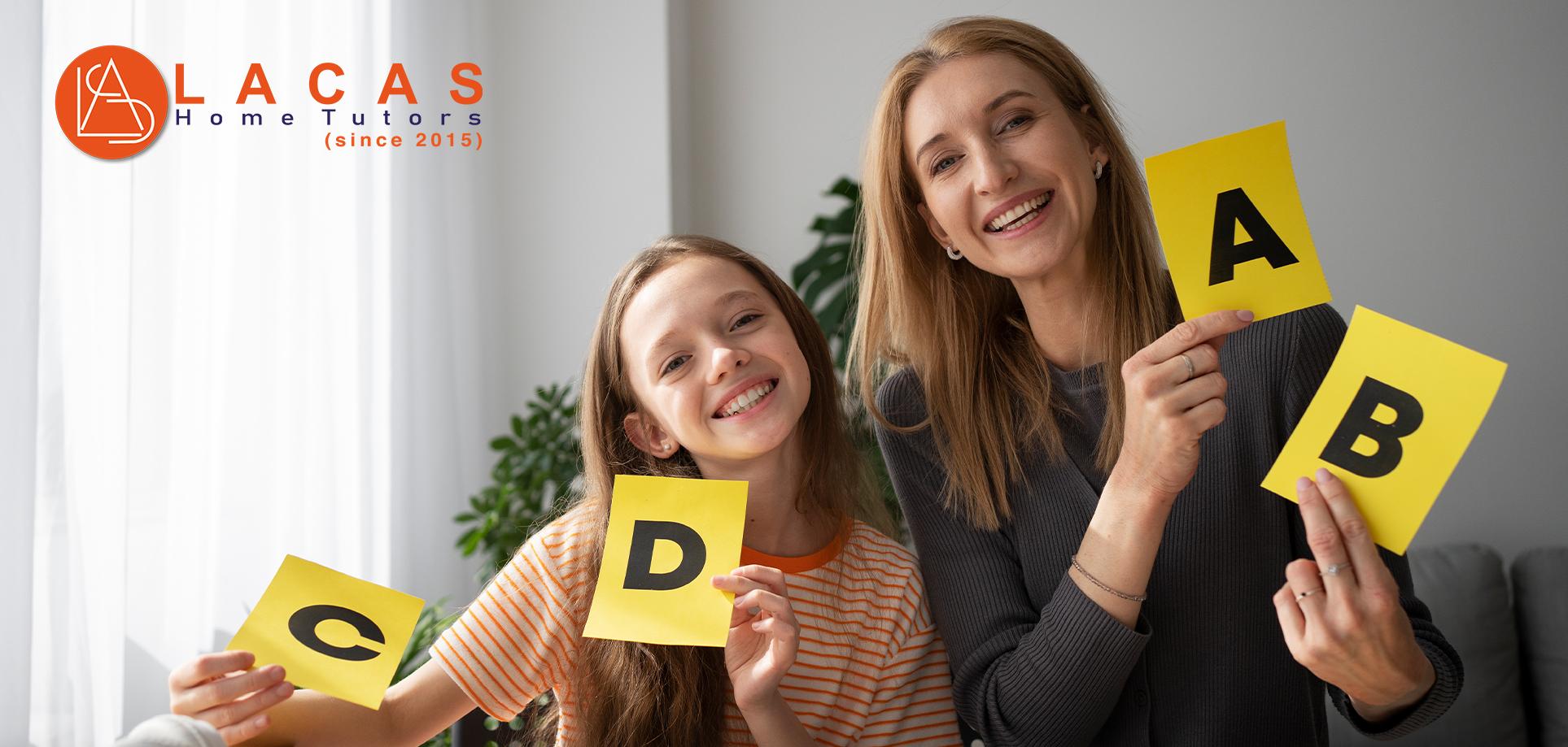 Tutor and student holding alphabet cards